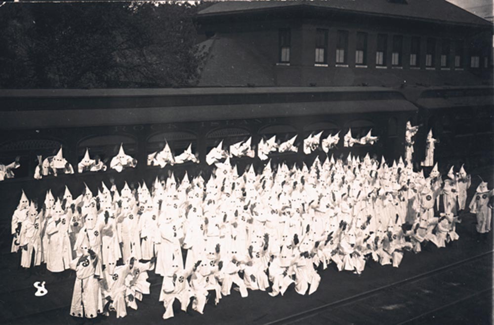 Klan members posed with a railroad car