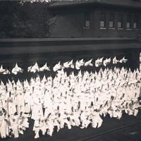 Klan members posed by train car