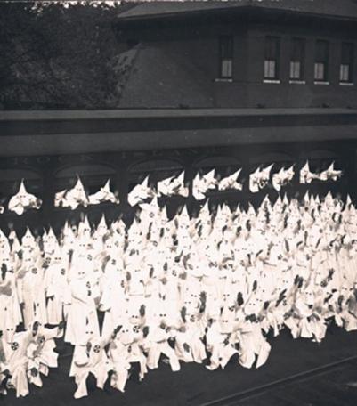 Klan members posed by train car